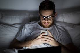 Man using a laptop in a dim room
