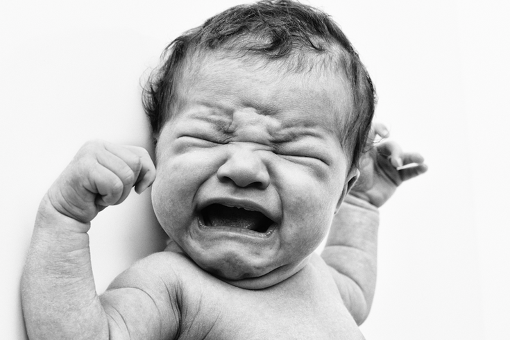Parent calming a crying baby