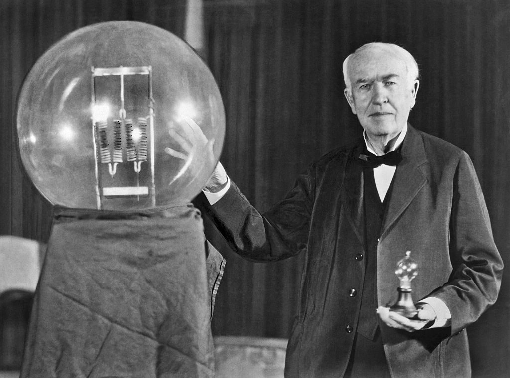 Noted inventor Thomas Edison at the lightbulb's golden jubilee anniversary banquet in his honor, Orange, New Jersey, October 16, 1929. He is exhibiting in his hand a replica of his first  successful incandescent lamp which gave 16 candlepower of illumination, in contrast to the latest lamp, a 50,000 watt, 150,000 candlepower lamp. (Photo by Underwood Archives/Getty Images)